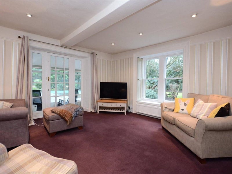 A further sitting room features a pebble effect gas fire and a glazed door leading into a conservatory, which overlooks the formal gardens, tennis court and swimming pool.