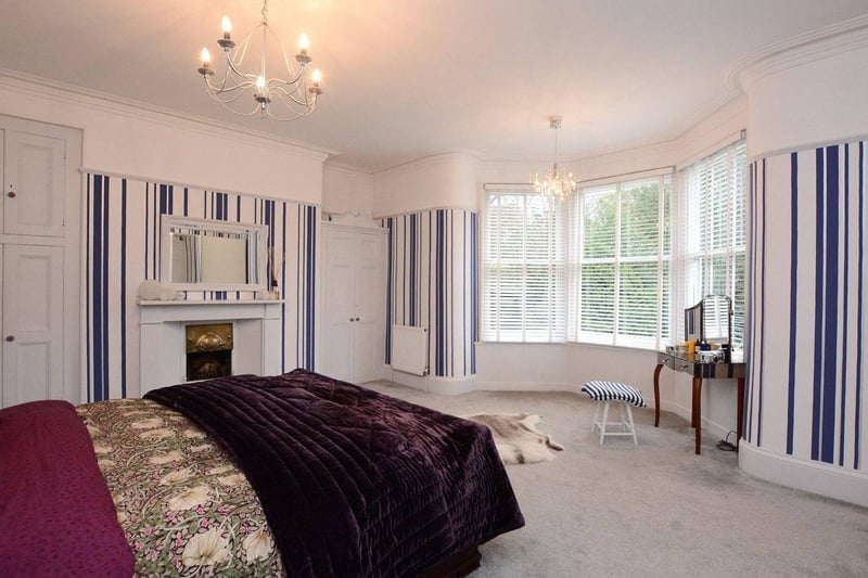 Upstairs, the large master bedroom has a bay window overlooking the gardens, as well as a feature fireplace, ample fitted wardrobes and a large en-suite bathroom.