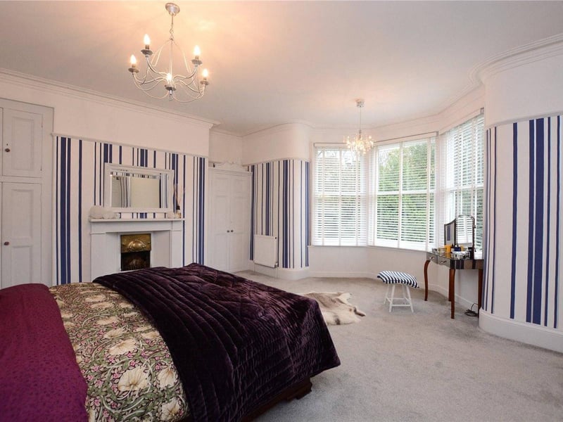 Upstairs, the large master bedroom has a bay window overlooking the gardens, as well as a feature fireplace, ample fitted wardrobes and a large en-suite bathroom.