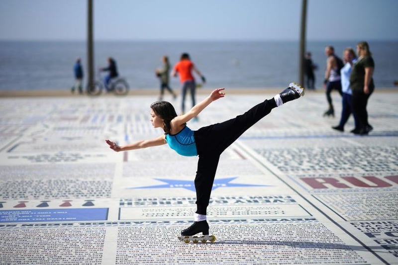 A young girl practices her skating skills in the Spring sunshine on Blackpool promenade as parts of the UK saw the warmest day of the year so far on March 30, 2021