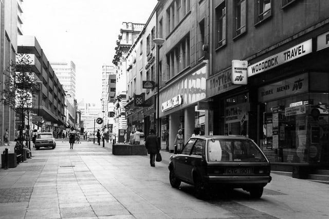 A view looking up Albion Street towards The Headrow. In the left centre of the scene is the intersection of Commercial Street (right) and Bond Street (left). On the left edge is the corner of the Bond Street Centre.