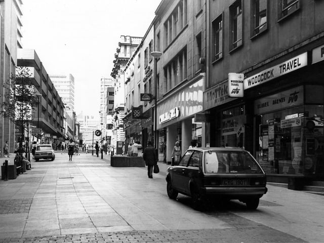 A view looking up Albion Street towards The Headrow in February 1980. In the left centre of the scene is the intersection of Commercial Street (right) and Bond Street (left). On the left edge is the corner of the Bond Street Centre.