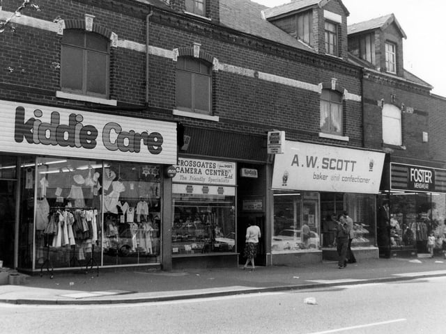 A parade of shops on Austhorpe Road featuring, from left, Kiddie Care children's wear, Crossgates camera centre, A.W.Scott, baker and confectioner and Foster menswear.
