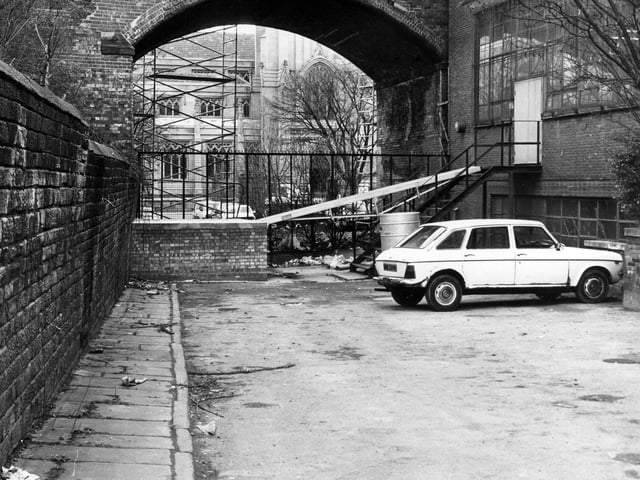 Church Lane, a small lane off New York Street at the side of St. Peter's graveyard which is here blocked off by railings in front of the railway bridge. Pictured in March 1986.