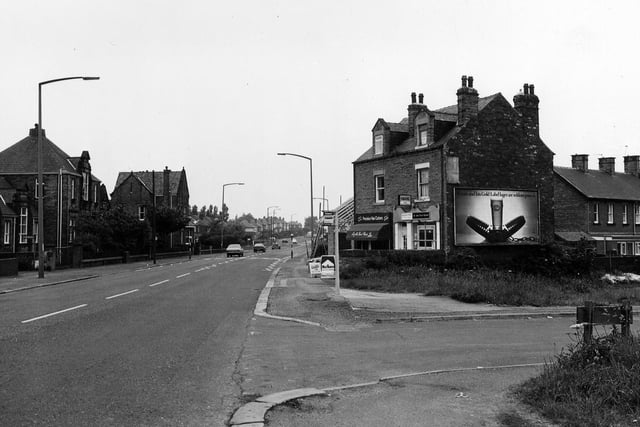 Bradford Road in Tingley from the junction with Fenton Street. Next to this is a pair of shops, Millan Stores, off licence, then David Charles, hairdressers, who are having an extension built to the side.