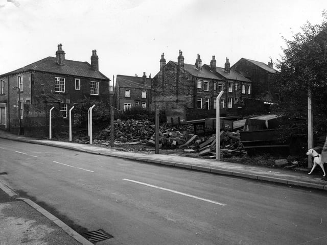 Albert Road in December 1981 showing a vacant site strewn with builders' rubble. Houses in the background face on to Ackroyd Street.