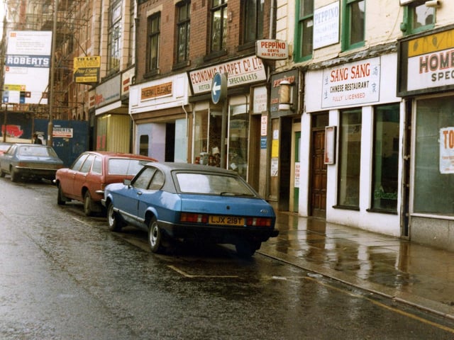 The east side of Briggate in November 1980. Shops include Fingernail Elegance, Manicurist, Economic Carpet Co. Ltd.and Sang Sang Chinese restaurant with Peppino, gents' hair stylist, above.