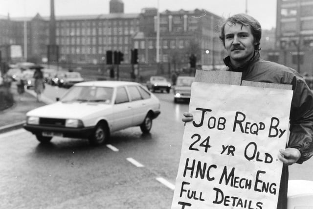From the traffic island near Leeds International Pool, Frank Howarth holds aloft his sign asking for work - in the hope that some passing driver can solve his dilemma.