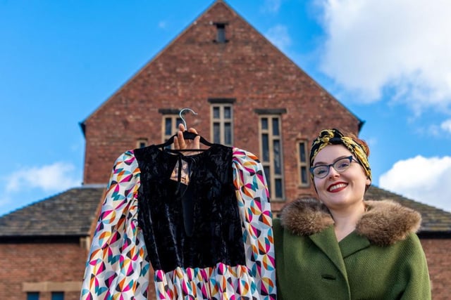 Emily Hughes, Brand & Event Manager of Judys' Vintage Fair, holding a dress from Tallula Vintage