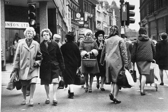 Give us a smile! These shoppers on Briggate are all wrapped up in the autumn of 1967.