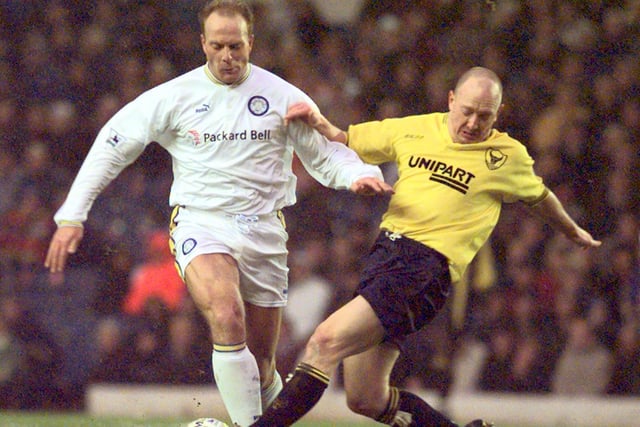 Robert Molenaar drives forward as Oxford United's Stuart Massey tries to tackle him.