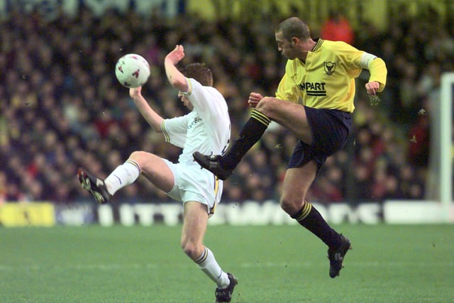 Alan Maybury closes down Oxford United captain Mike Ford as he attempts to cleaer the ball.
