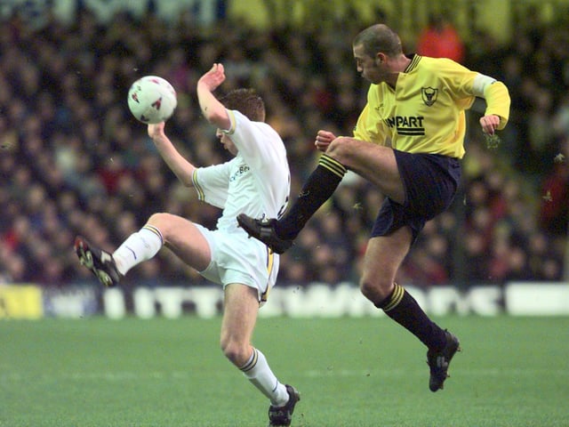 Alan Maybury closes down Oxford United captain Mike Ford as he attempts to cleaer the ball.