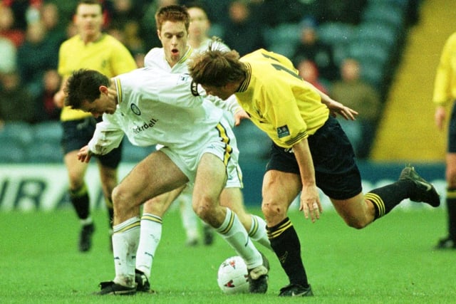 David Wetherall battles for the ball as teammate Alan Maybury looks on.