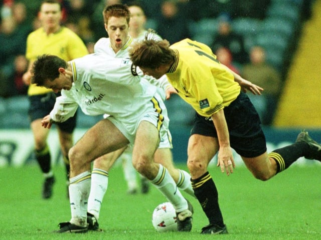 David Wetherall battles for the ball as teammate Alan Maybury looks on.