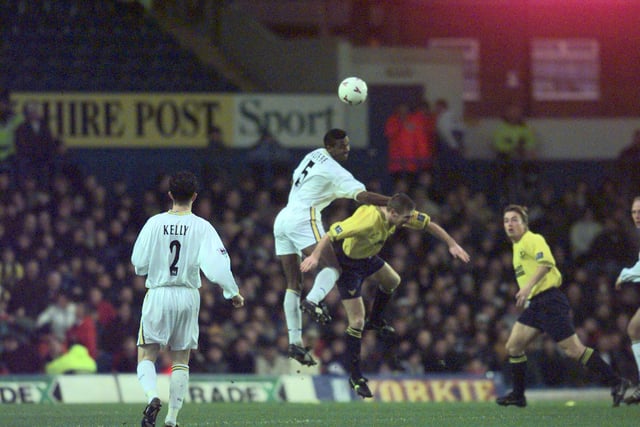 Lucas Radebe rises high above Oxford United captain Mike Ford.