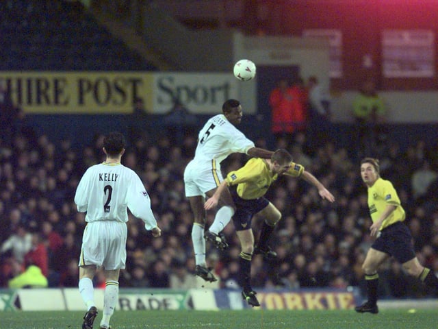 Lucas Radebe rises high above Oxford United captain Mike Ford.
