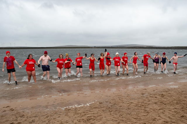 On New Year's Day red-clad swimmers took to the water at Gaddings Dam, near Todmorden.