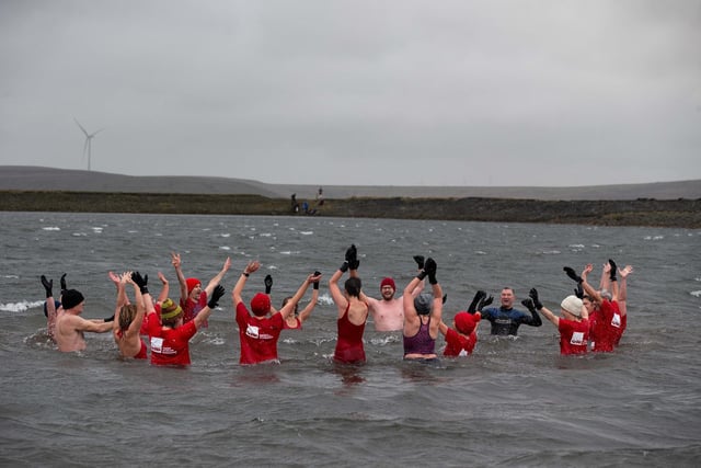 On New Year's Day red-clad swimmers took to the water at Gaddings Dam, near Todmorden.