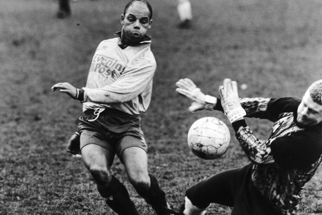 Blue Light goalkeeper Mark Wilson's hands signal a stop to Yorkshire Evening Post driver David Bartholomew in a Grove Park attack during a Wakefield Tetley League First Division game at Stanley Royd. Grove Park, sponsored by the YEP, eventually finished 1-0 winners.