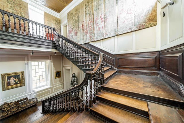 This impressive oak staircase sweeps up from the great hall to the first floor, and a galleried landing.
