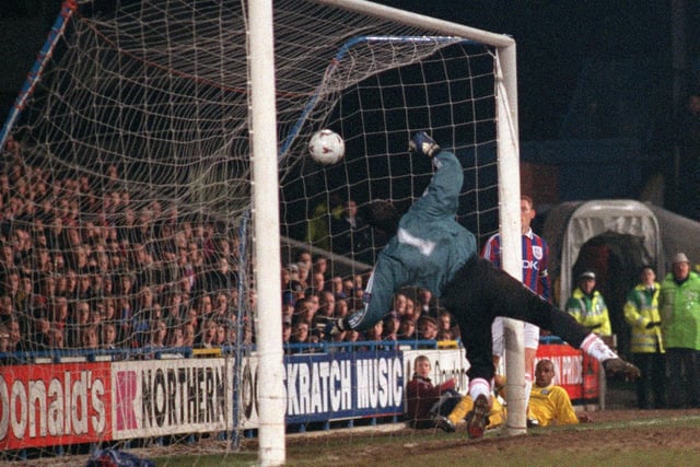Crystal Palace goalkeeper Chris Day can only watch as Leif Andersen scores an own goal, to put Leeds 2-1 in front.