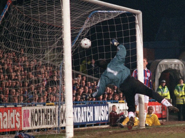 Crystal Palace goalkeeper Chris Day can only watch as Leif Andersen scores an own goal, to put Leeds 2-1 in front.
