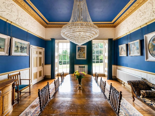 This elegant room is fit for a banquet and has the long windows seen throughout the property, that allow a great deal of natural light.