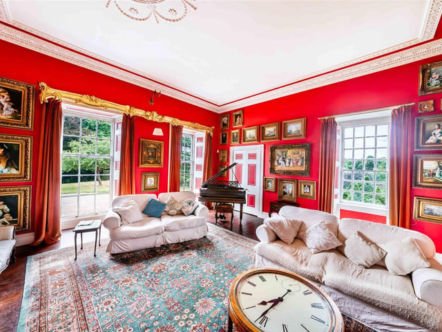 Detailed decoration and large windows with garden views add to the splendour of this lovely reception room.
