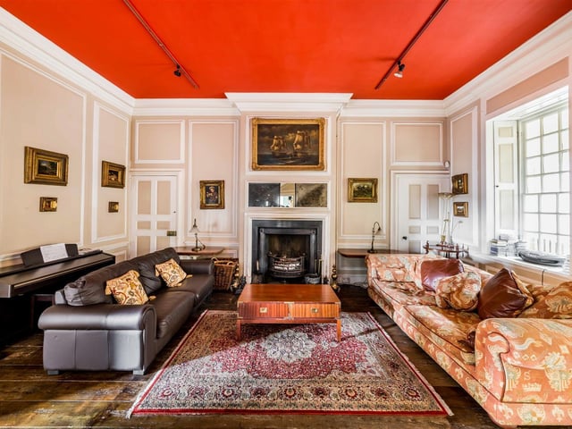 A central fireplace is a focal point of this light and comfortable room within Birthwaite Hall.