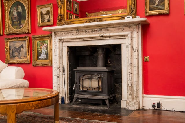 This grand marble fireplace with stove is a feature of the drawing room.