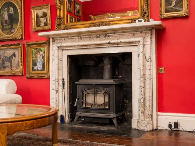 This grand marble fireplace with stove is a feature of the drawing room.