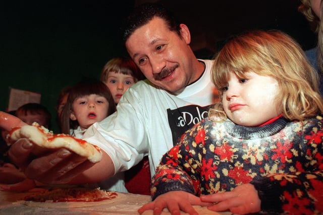 Megan Evans tries her hand at making pizza under the watchful eye of chef Manlio Bozzo, when she and other children from Clarendon Nursery visited La Dolce Vita restaurant on Vicar Lane.