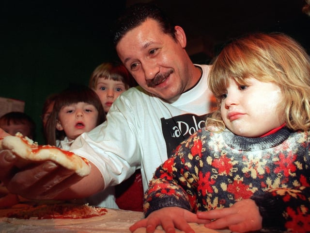 Megan Evans tries her hand at making pizza under the watchful eye of chef Manlio Bozzo, when she and other children from Clarendon Nursery visited La Dolce Vita restaurant on Vicar Lane.