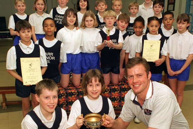 Olympic javelin thrower Mick Hill visited Carr Manor Primary where he presented the school's U-11s athletic team with the Leeds Primary Schools Indoor Athletics championship trophy and awards.