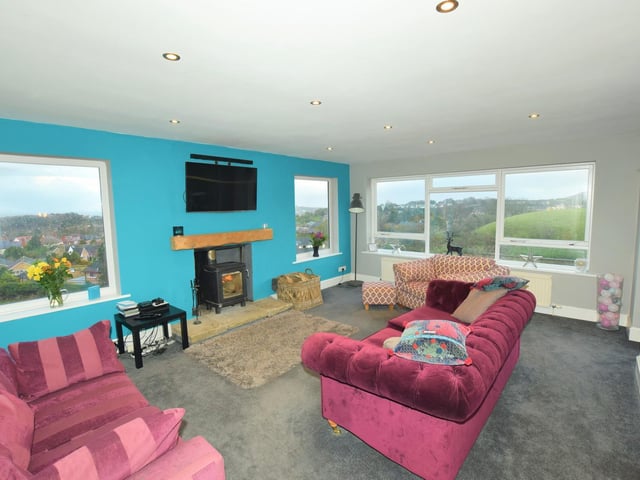 A central fireplace and the views through large windows feature in this well-lit room.