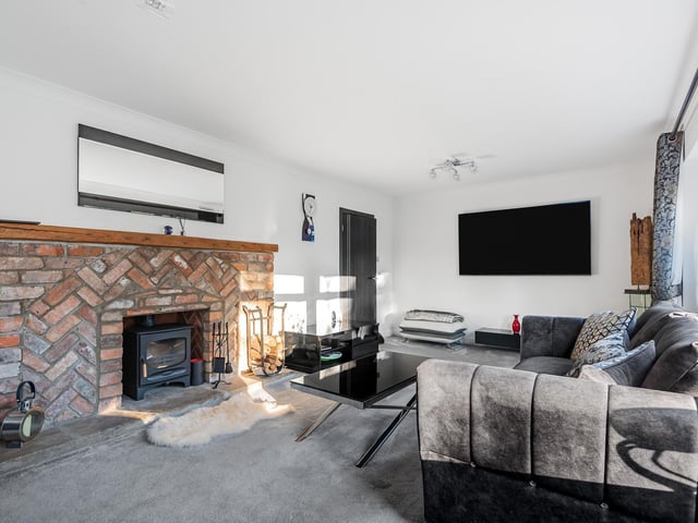 The brick fireplace is a central focal point of this sitting room
