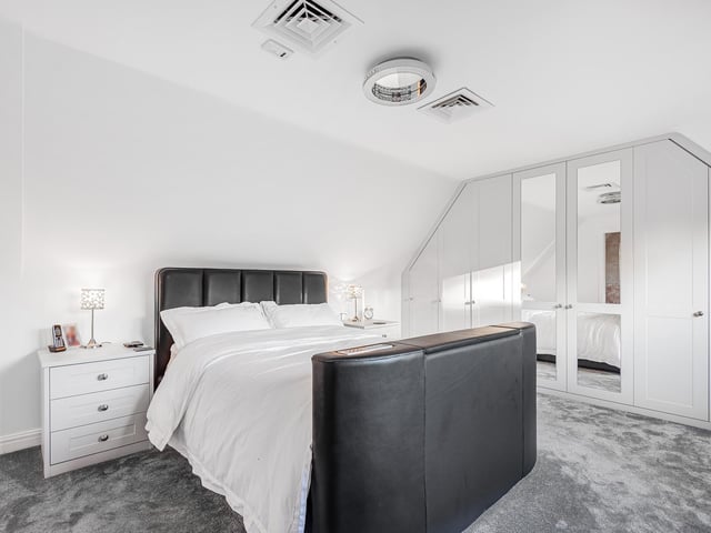 Another double bedroom with fitted furniture within the property