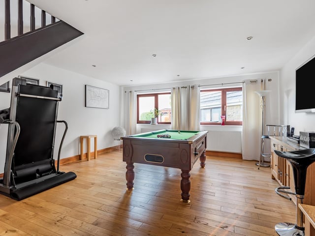 This spacious room currently used for games, could easily adapt to other use