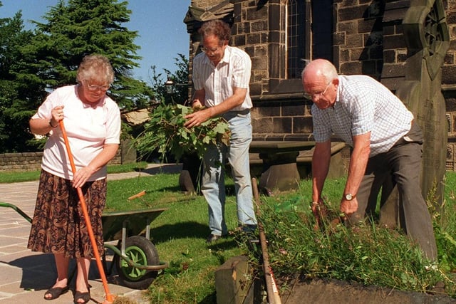 Volunteers tidy up the churchyard at St Peter's Church in July 1997.  Pictured, from left are verger Jean Grimshaw, husband and tree officer Raymond and church warden Eric Thornton.