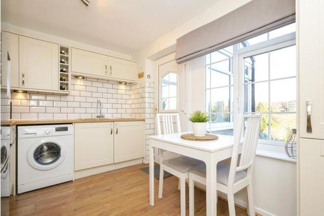 Access to the kitchen is through the porch, with the windows overlooking the front garden.