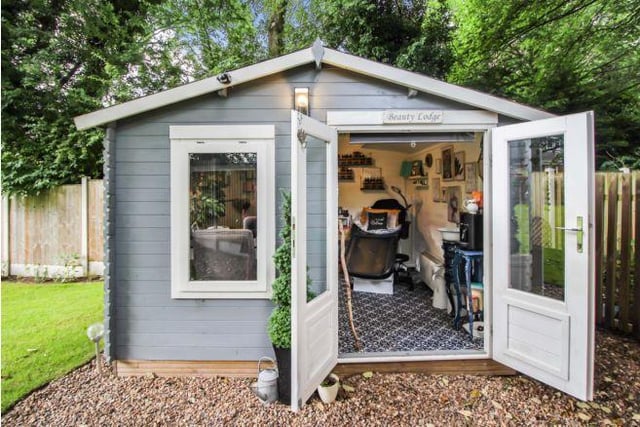 It includes a summerhouse with power and lighting.