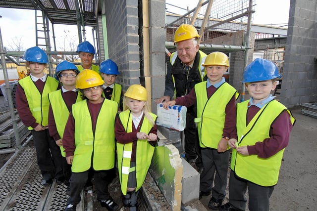 Wood Fold Primary School pupils and deputy headteacher Katherine Wain-Mahoney with their time capsule on the building site of their new classrooms in 2008