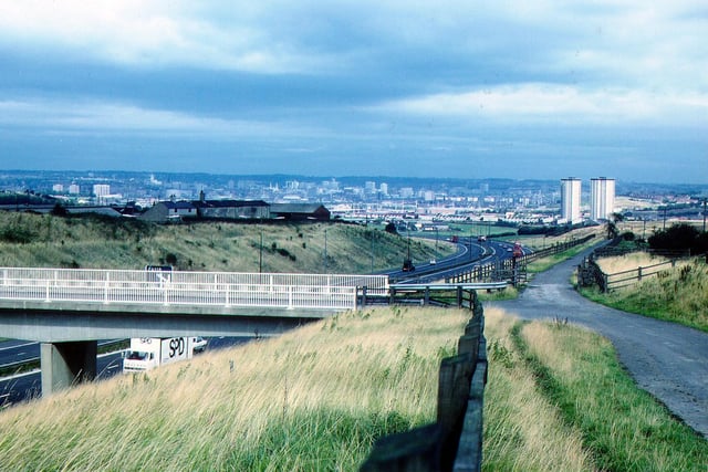 The Rooms Lane bridge over the M621 motorway at Morley pictured in September 1983, looking northeast towards Cottingley and Beeston with the city centre in the distance. The tower blocks of Cottingley Heights and Cottingley Towers can be seen on the right. PIC: David Atkinson Archive