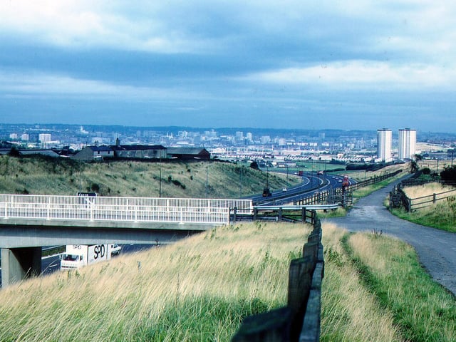 The Rooms Lane bridge over the M621 motorway at Morley pictured in September 1983, looking northeast towards Cottingley and Beeston with the city centre in the distance. The tower blocks of Cottingley Heights and Cottingley Towers can be seen on the right. PIC: David Atkinson Archive