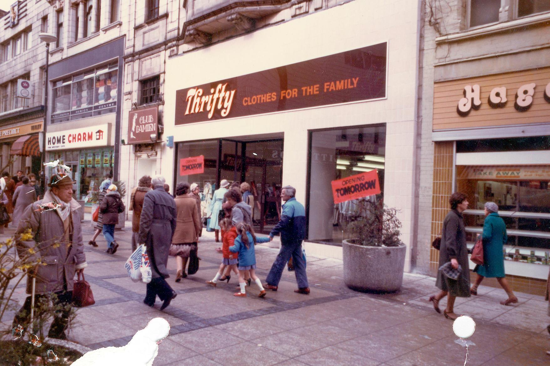 Kirkgate in April 1983. The Precinct public house is on the left followed by Home Charm. Next to this is the entrance to Club Damien night club, which occupies the floor above. Thrifty, Clothes for the Family, due to be opened on the following day. On the right is Hagenbach bakers. 