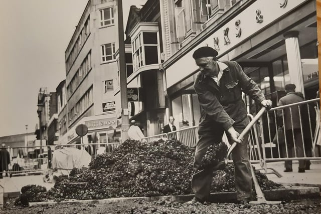 This photo is undated but suggests it could be the 1980s or the late 70s. Marks and Spencer to the right and Littlewoods in the distance. Do you recognise the man with the shovel?