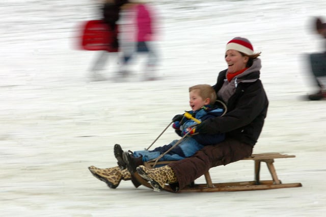 This pair enjoy a spot of sledging in Avenham Park, Preston after heavy snowfall
