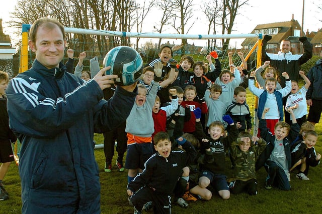 Fleetwood Town FC’s Jamie Milligan whose goal has been viewed almost two and a half million times on YouTube. Jamie is pictured celebrating with children from his soccer school at St Thomas School, St Annes