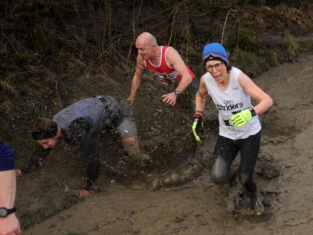 Some runners struggled to maintain their footing as they battled through the mud.
